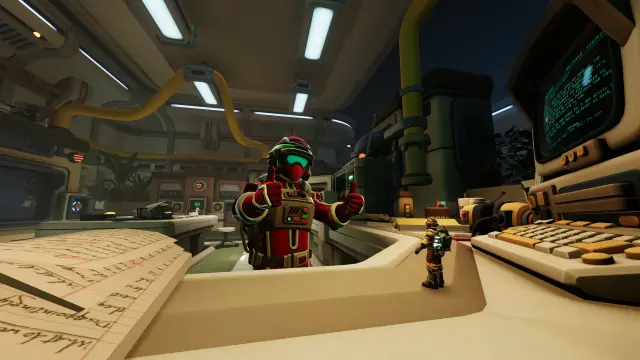 An Explorer and a miniature partner beside a laboratory computer